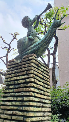 Statues of children riding fish and snail 사진 3